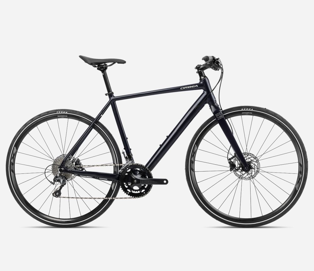 Bicicleta urbana Orbea Urban Speed 2024 con cuadro de aluminio, transmisión Shimano Tiagra 10v, frenos de disco hidráulicos Shimano MT200 y ruedas Shimano WH-RX010 con neumáticos Kenda 700x32 reflectantes.