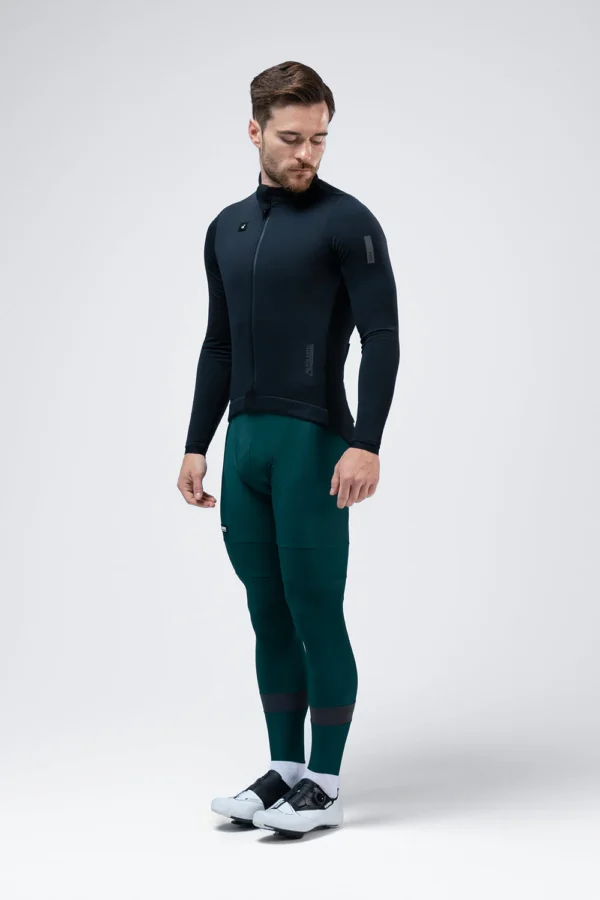 Description: Ultra-elastic version of our iconic winter jacket, a true benchmark in thermal comfort and aerodynamics for the coldest months. Thanks to a solid fabric made with micro polyamide, we achieve complete freedom of movement with a very pleasant feel. The front panel with Polartec® Windbloc™ offers wind protection, water repellency, and exceptional breathability, ensuring the perfect balance between insulation and ventilation. The interior with microfleece provides extra warmth in extreme conditions, while the exterior receives an additional water-repellent treatment, providing total protection against moisture. The sleeves have been made with Polartec® Power Shield™ protection on the upper part and a lower panel in winter lycra that achieves an optimal balance between protection and comfort. Its design has also evolved, with sharper side panels, an optimized back silhouette, and new minimalist cuffs. It maintains its Perfect Fit fit, snug but adaptable to different types of cyclists and disciplines. In terms of storage, it has three rear pockets with the GRS system and a lower gusset to improve ventilation, as well as a fourth zippered pocket to securely store valuables. A jacket that redefines the standard of protection and performance in winter. New optimized pattern. Fabric with Polartec® Windbloc™. Additional exterior water-repellent treatment. Back with breathable microfleece. Sleeves with Polartec® Power Shield™. Minimalist cuffs. Thermo-sealed zipper with protectors and puller. 3 rear pockets with GRS system. Extra zippered pocket. Large-format interior mesh pocket. Waist with rear silicone band. Reflective details.