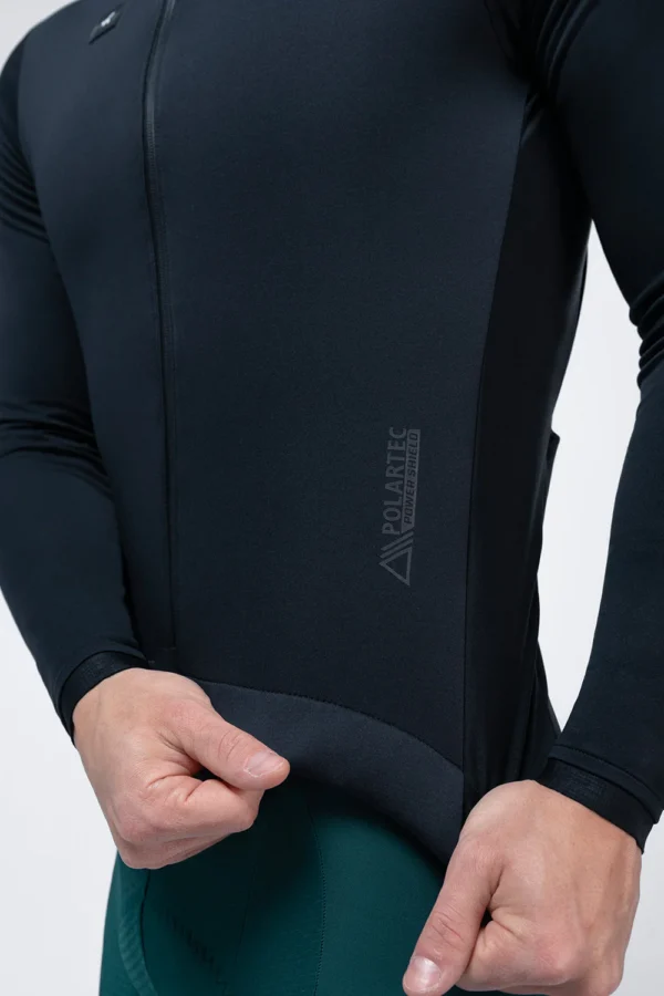 Description: Ultra-elastic version of our iconic winter jacket, a true benchmark in thermal comfort and aerodynamics for the coldest months. Thanks to a solid fabric made with micro polyamide, we achieve complete freedom of movement with a very pleasant feel. The front panel with Polartec® Windbloc™ offers wind protection, water repellency, and exceptional breathability, ensuring the perfect balance between insulation and ventilation. The interior with microfleece provides extra warmth in extreme conditions, while the exterior receives an additional water-repellent treatment, providing total protection against moisture. The sleeves have been made with Polartec® Power Shield™ protection on the upper part and a lower panel in winter lycra that achieves an optimal balance between protection and comfort. Its design has also evolved, with sharper side panels, an optimized back silhouette, and new minimalist cuffs. It maintains its Perfect Fit fit, snug but adaptable to different types of cyclists and disciplines. In terms of storage, it has three rear pockets with the GRS system and a lower gusset to improve ventilation, as well as a fourth zippered pocket to securely store valuables. A jacket that redefines the standard of protection and performance in winter. New optimized pattern. Fabric with Polartec® Windbloc™. Additional exterior water-repellent treatment. Back with breathable microfleece. Sleeves with Polartec® Power Shield™. Minimalist cuffs. Thermo-sealed zipper with protectors and puller. 3 rear pockets with GRS system. Extra zippered pocket. Large-format interior mesh pocket. Waist with rear silicone band. Reflective details.